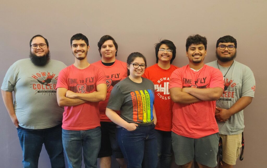 Seven students wearing various college tshirts