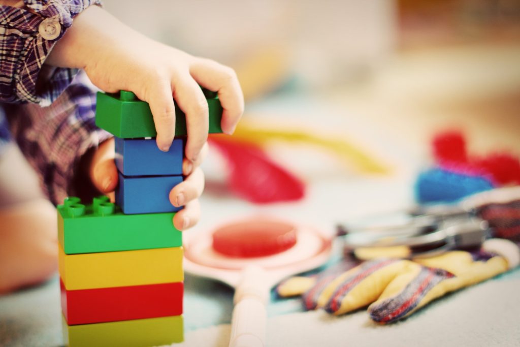 Closeup of child playing with Legos