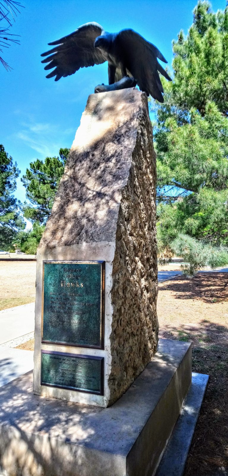 Stone time capsule with sculpture of hawk on Big Spring campus