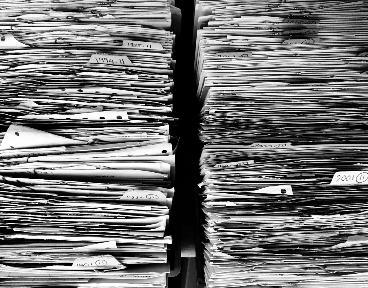 Greyscale of stacks of file folders