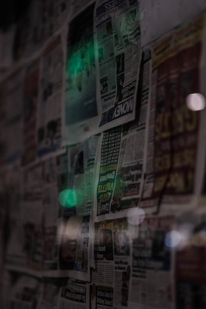 Newspapers seen through a rainy window